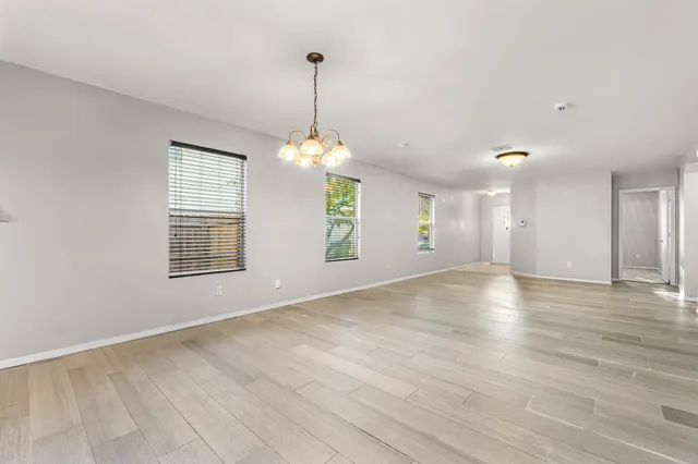 a view of a room with windows and chandelier