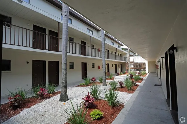 a front view of a building with potted plants