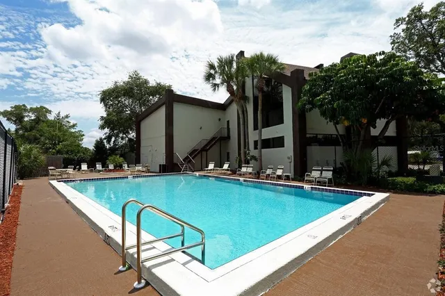 a view of swimming pool with chairs