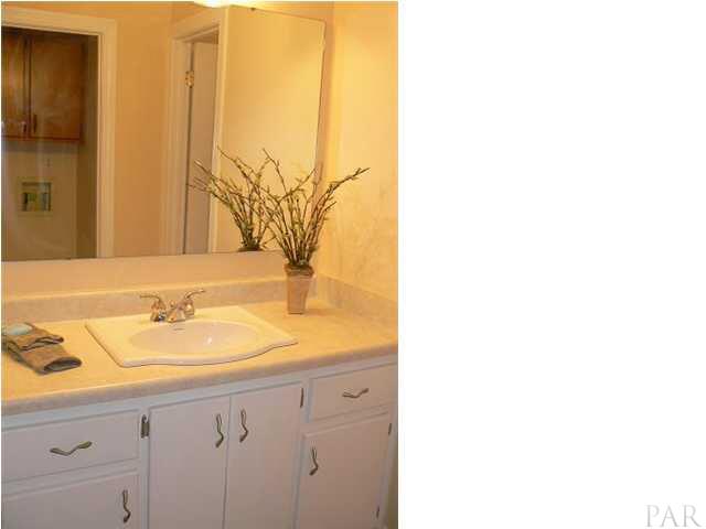 6045 Hilburn Road Pensacola, FL 32504 - Photo 15 of 18 The hall bath with landry facilities opposite the vanity.