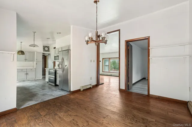 a view of a kitchen with a refrigerator and a hallway