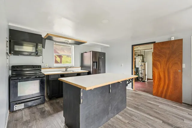 a kitchen with granite countertop a sink and cabinets