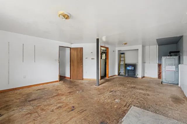 an empty room with a door and mirror