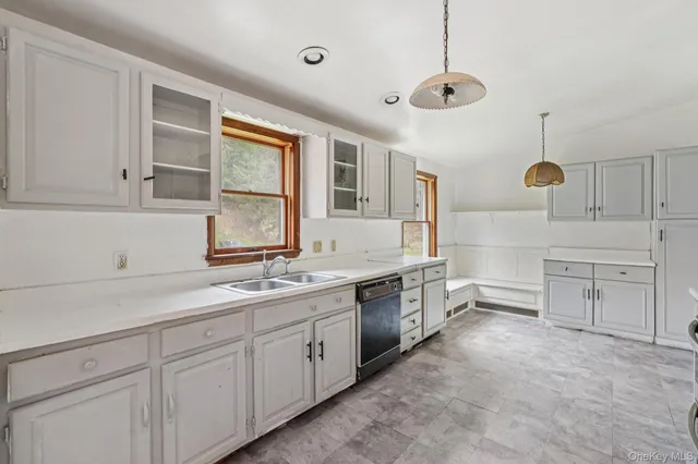 a kitchen with stainless steel appliances a stove a refrigerator and cabinets