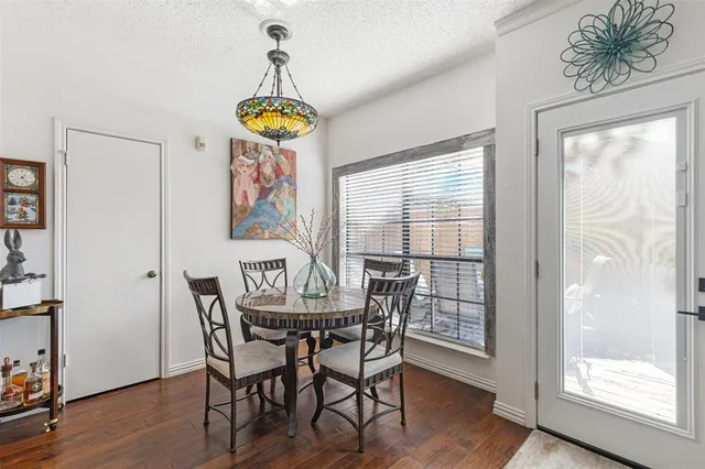 a view of a dining room with furniture wooden floor and front door