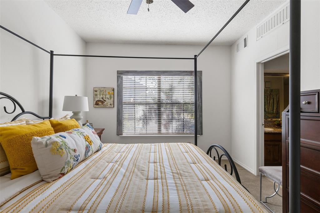 5619 Preston Oaks Road, Unit 502 Dallas, TX 75254 - Photo 15 of 33 a bedroom with a bed and a window