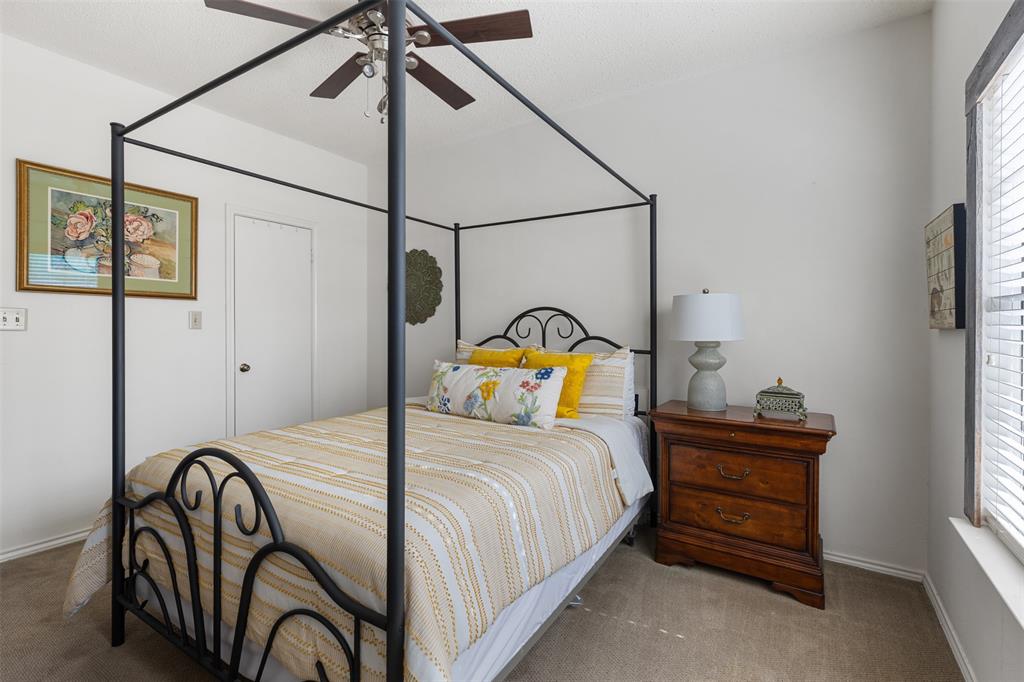 5619 Preston Oaks Road, Unit 502 Dallas, TX 75254 - Photo 16 of 33 a bedroom with a bed and a chandelier