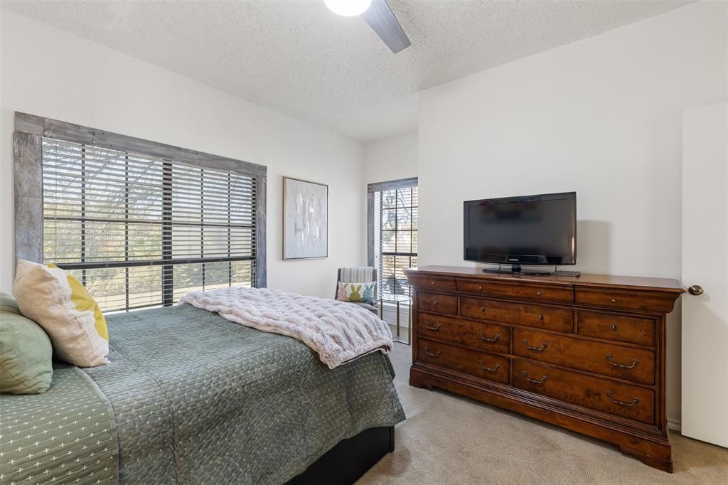 5619 Preston Oaks Road, Unit 502 Dallas, TX 75254 - Photo 19 of 33 a bedroom with a bed and a television