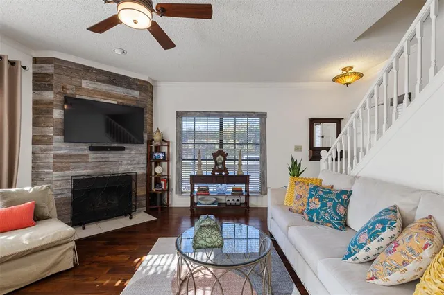 a living room with fireplace furniture and a flat screen tv