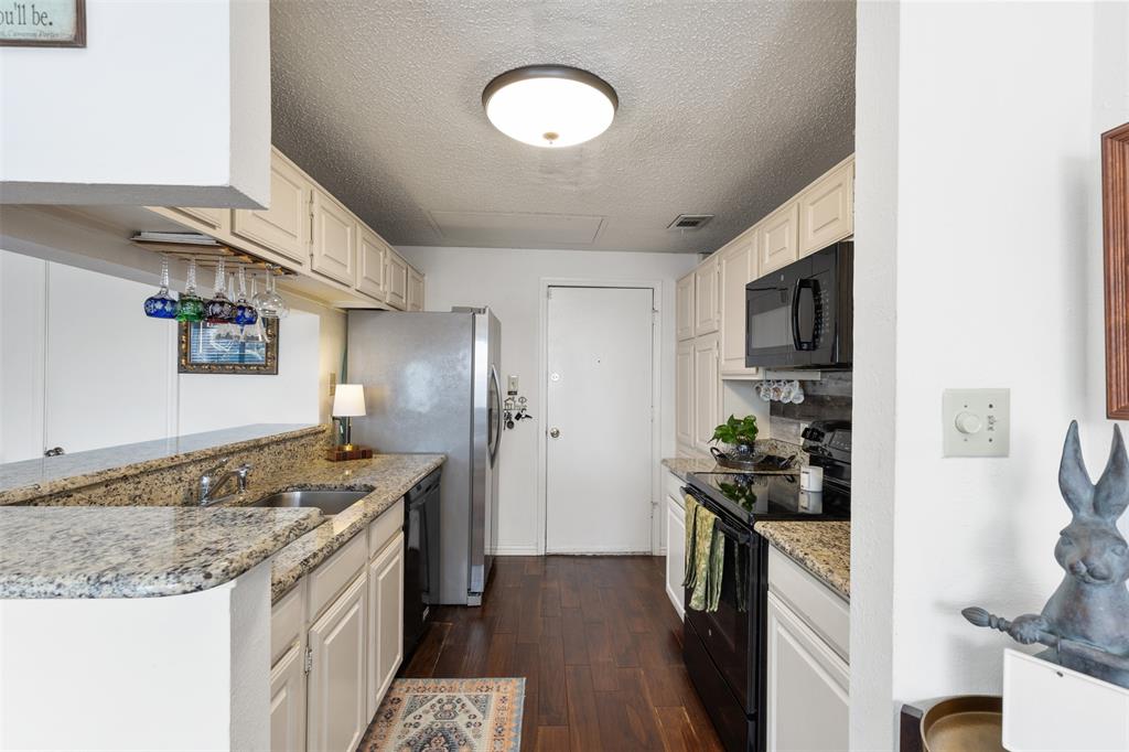 5619 Preston Oaks Road, Unit 502 Dallas, TX 75254 - Photo 6 of 33 a kitchen with a sink stove and refrigerator