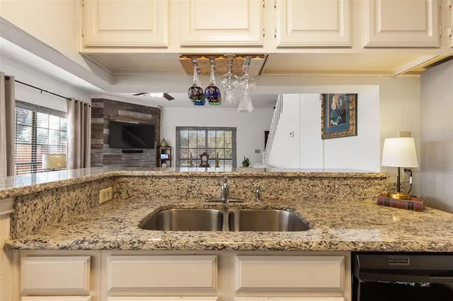 a kitchen with stainless steel appliances granite countertop a sink and a granite counter tops