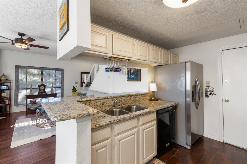 5619 Preston Oaks Road, Unit 502 Dallas, TX 75254 - Photo 10 of 33 a kitchen with stainless steel appliances granite countertop a stove a refrigerator and a white cabinets