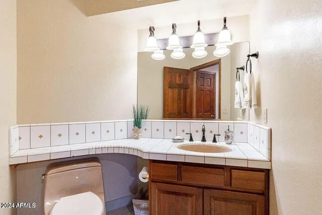 a bathroom with a sink vanity and a mirror