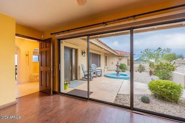 a view of a porch with a table and chairs and potted plants