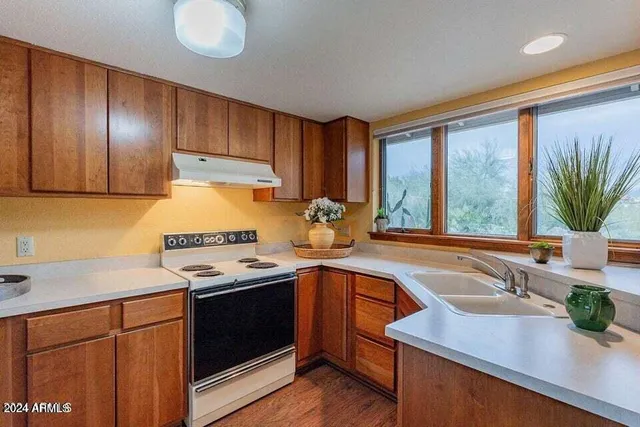 a kitchen with a sink stove and cabinets