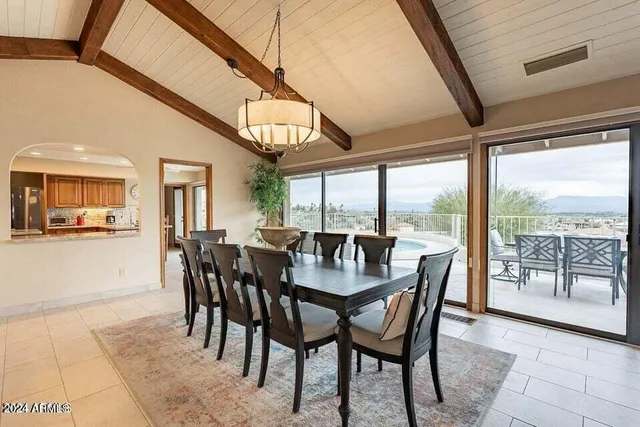 a dining room with furniture a chandelier and wooden floor
