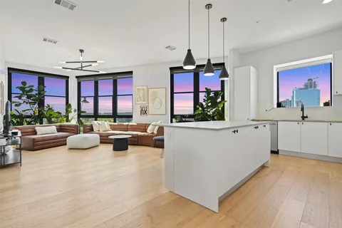 a living room with furniture and a chandelier