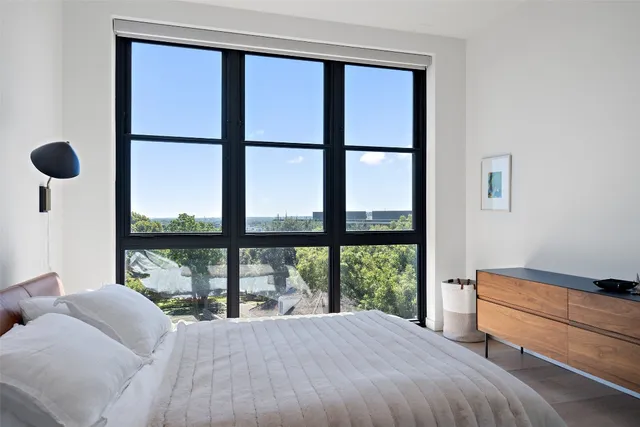 a bathroom with a granite countertop sink a mirror and shower