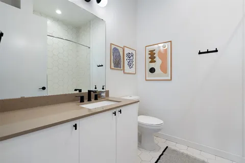 a bathroom with a sink toilet and shower