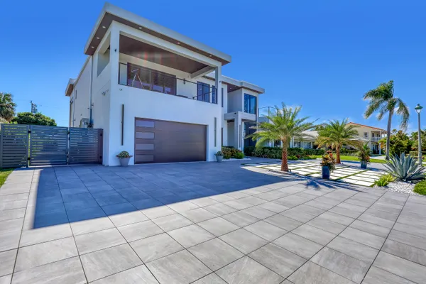 a view of house with backyard and sitting area