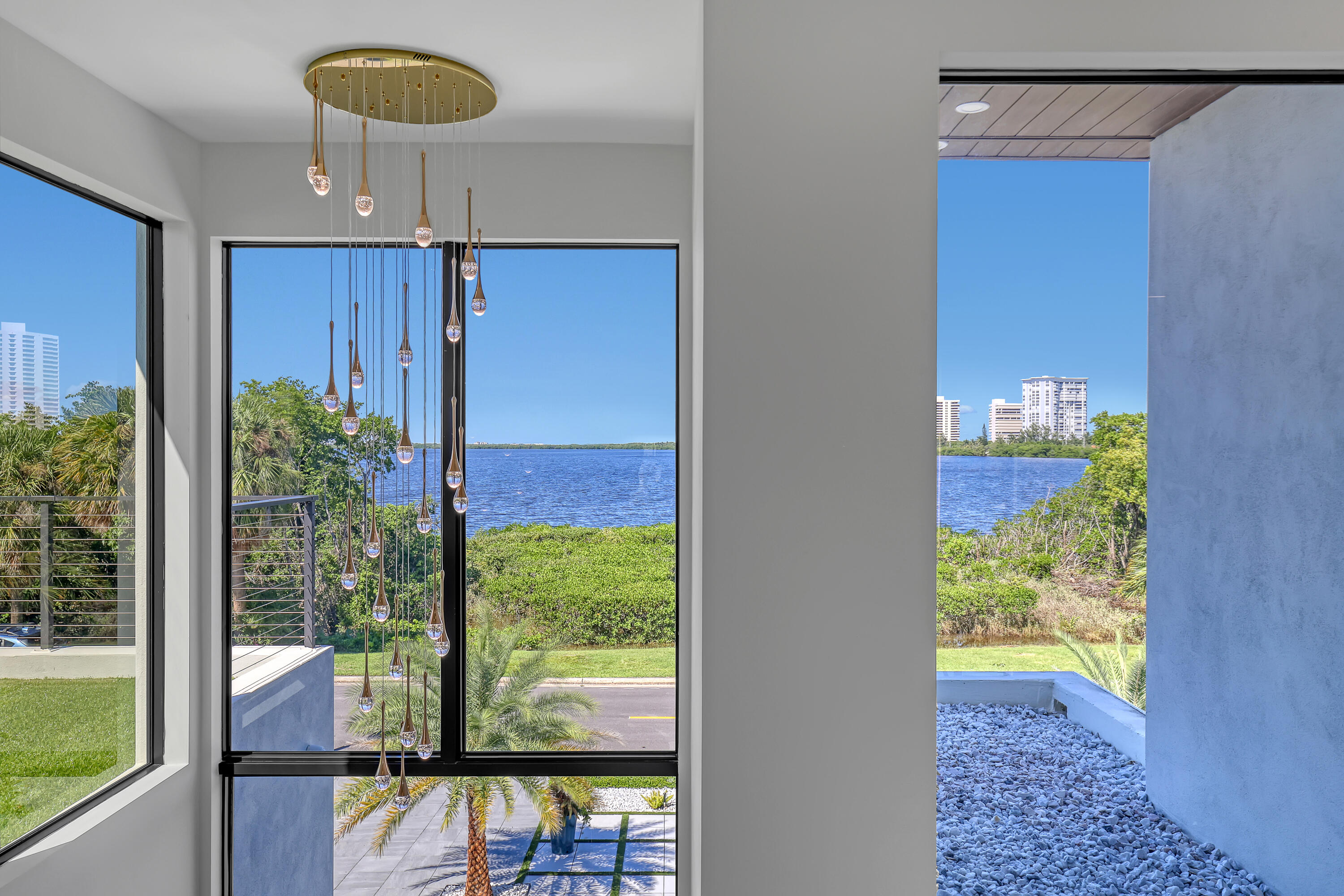 1161 Pine Point Road Riviera Beach, FL 33404 - Photo 24 of 58 a view of a porch with a dining table and chairs