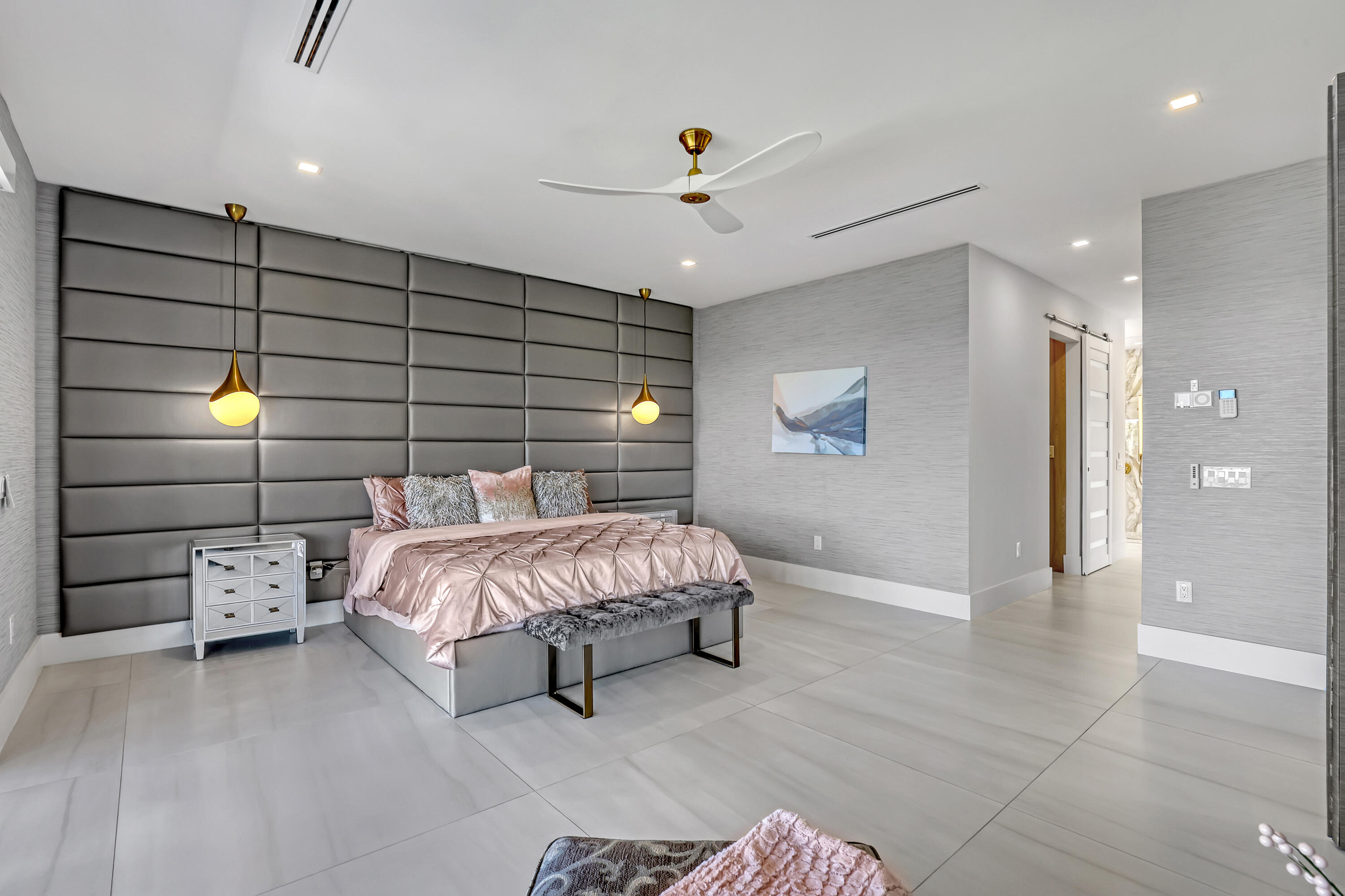 1161 Pine Point Road Riviera Beach, FL 33404 - Photo 30 of 58 a spacious bedroom with a bed and a couch