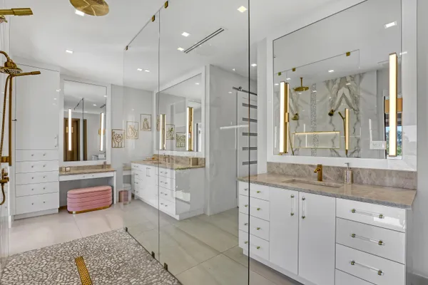 a bedroom with a bed and large windows