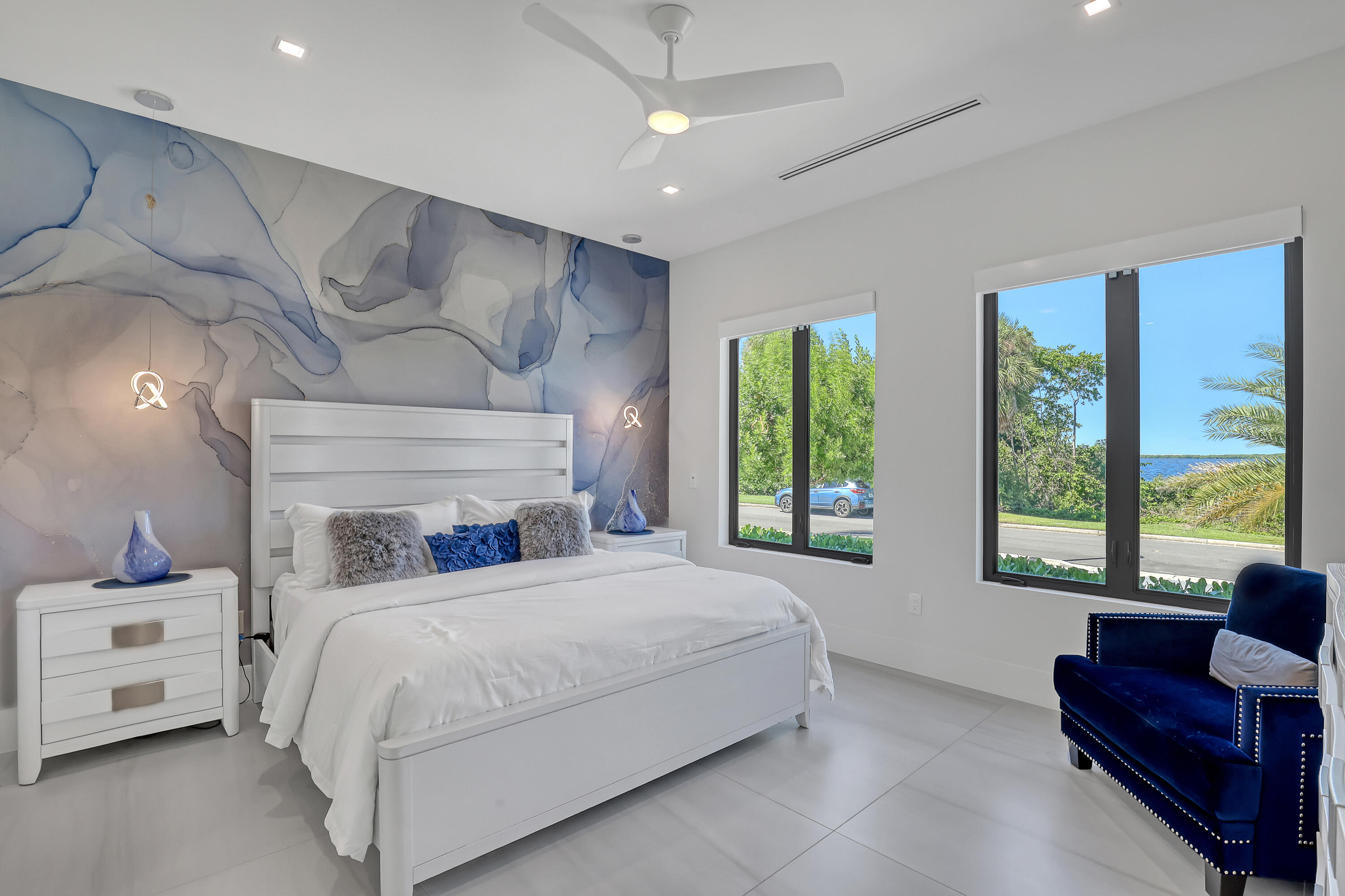 1161 Pine Point Road Riviera Beach, FL 33404 - Photo 37 of 58 a bedroom with a bed and large windows