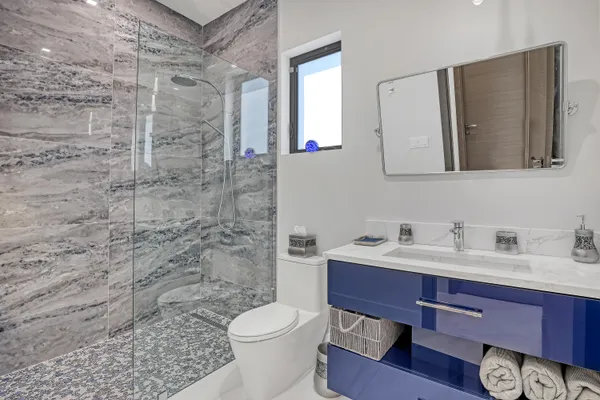 a bathroom with a toilet sink and shower