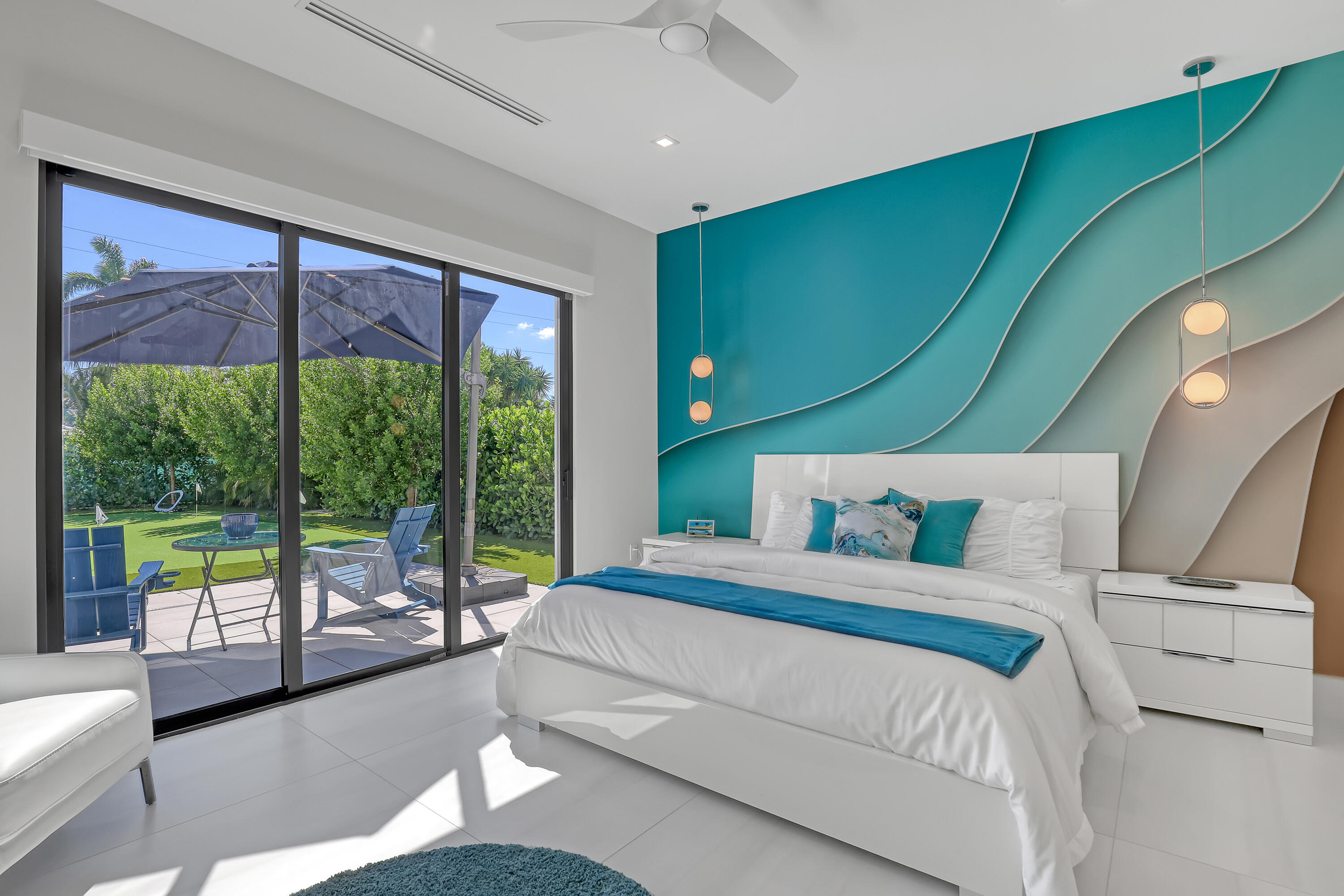 1161 Pine Point Road Riviera Beach, FL 33404 - Photo 41 of 58 a bedroom with a bed and a large window