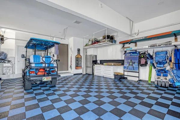 a view of a patio with chairs and a table under an umbrella
