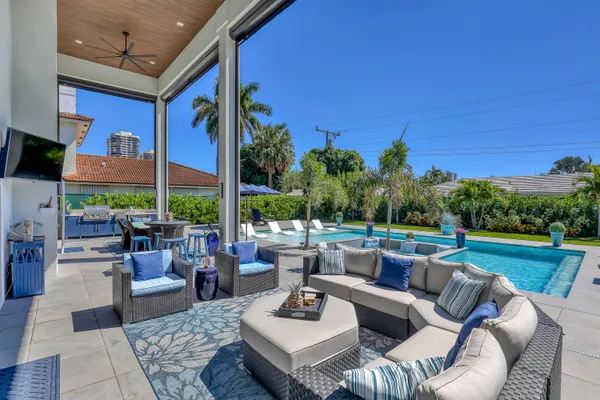 a view of a house with backyard porch and sitting area