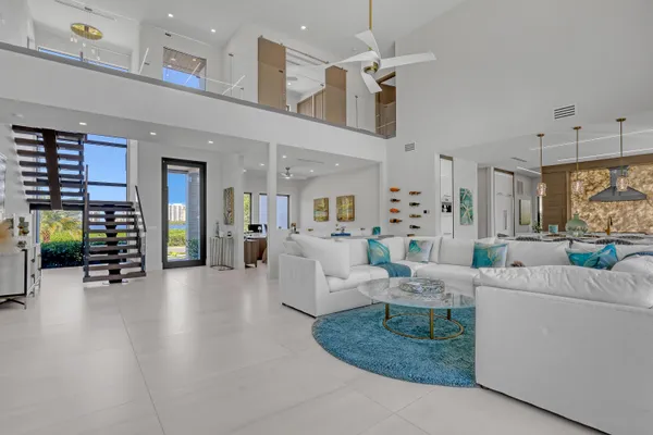 a living room with furniture and a floor to ceiling window
