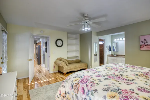 a bedroom with a bed and ceiling fan