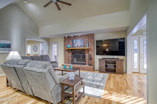 a living room with furniture a flat screen tv and a fireplace