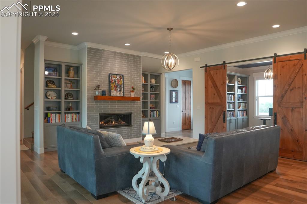 1183 2nd Street Penrose, CO 81240 - Photo 25 of 50 a living room with furniture a fireplace and a chandelier