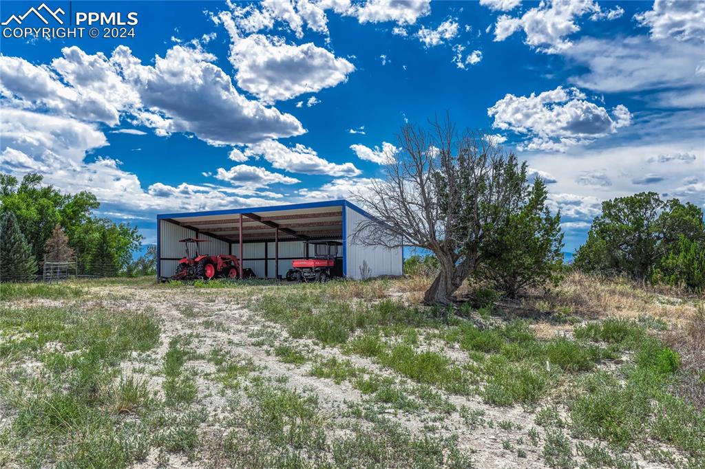 1183 2nd Street Penrose, CO 81240 - Photo 50 of 50 a backyard of a house with table and chairs plants and large trees