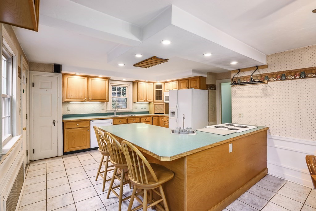 30 St Elmo Road Worcester, MA 01602 - Photo 25 of 42 a kitchen with stainless steel appliances granite countertop a sink a stove and a refrigerator