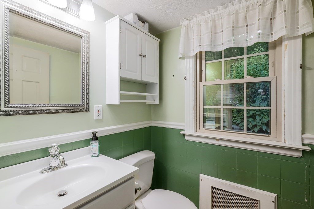 30 St Elmo Road Worcester, MA 01602 - Photo 29 of 42 a bathroom with a sink mirror toilet and window
