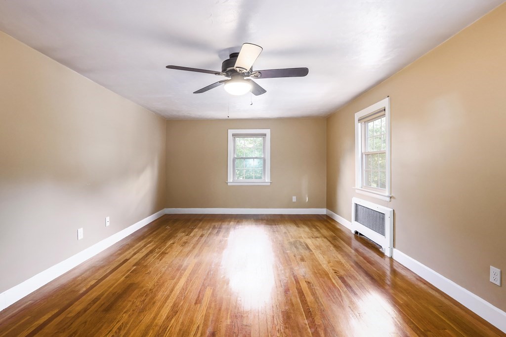 30 St Elmo Road Worcester, MA 01602 - Photo 31 of 42 an empty room with wooden floor fan and windows