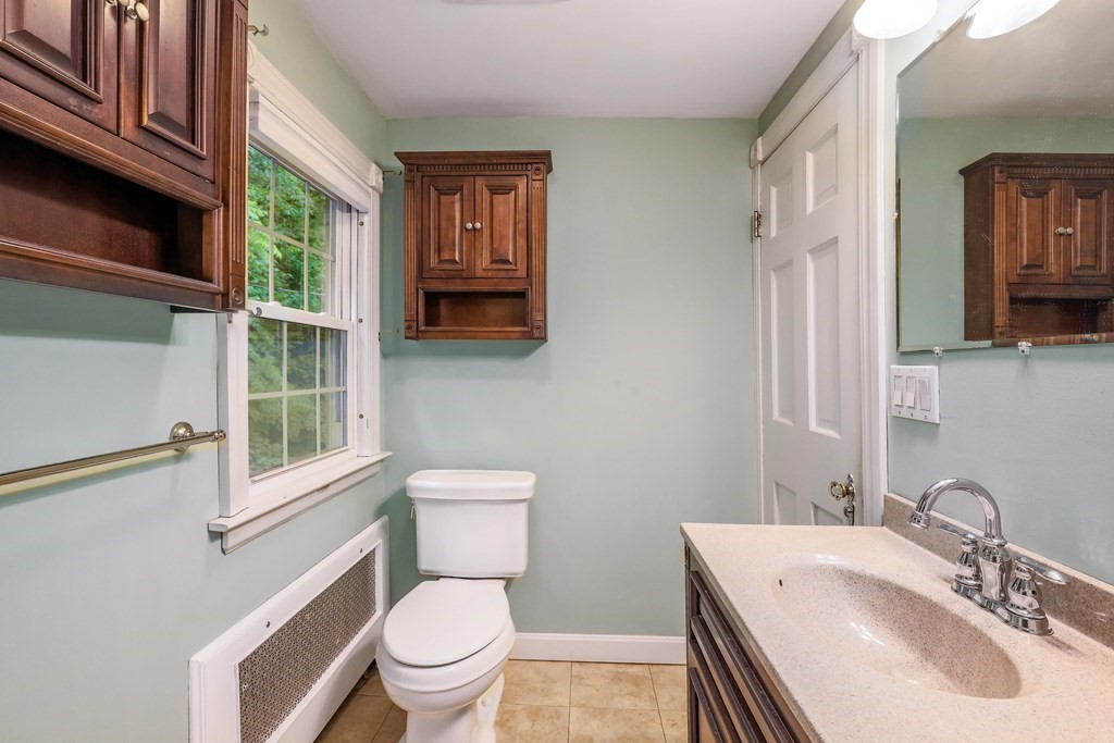 30 St Elmo Road Worcester, MA 01602 - Photo 36 of 42 a bathroom with a sink a toilet and a mirror
