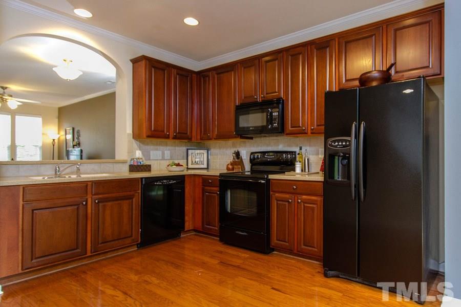 SPACIOUS kitchen with TILE BACKSPLASH and beautiful CABINETRY.