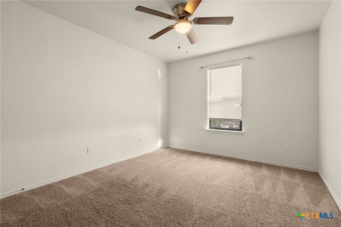 1103 Katelyn Circle Copperas Cove, TX 76522 - Photo 11 of 16 an empty room with a window and a fan