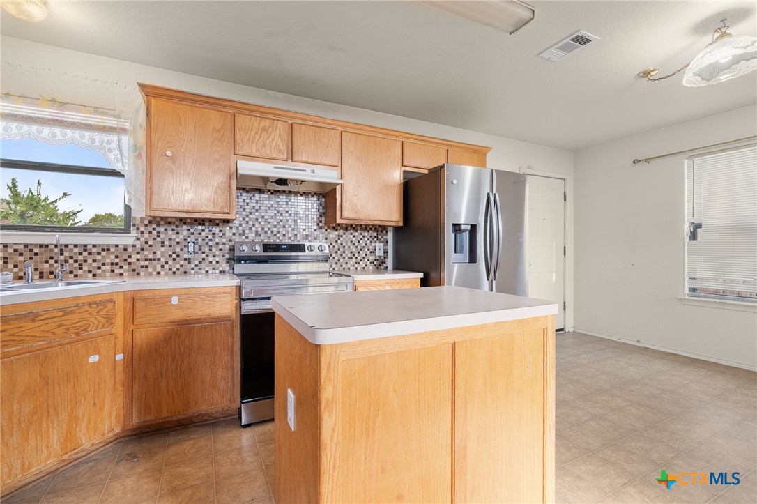 1103 Katelyn Circle Copperas Cove, TX 76522 - Photo 4 of 16 a kitchen with stainless steel appliances granite countertop a sink and cabinets