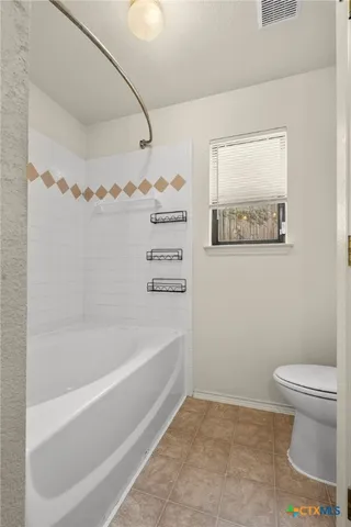 a bathroom with a toilet and a bathtub