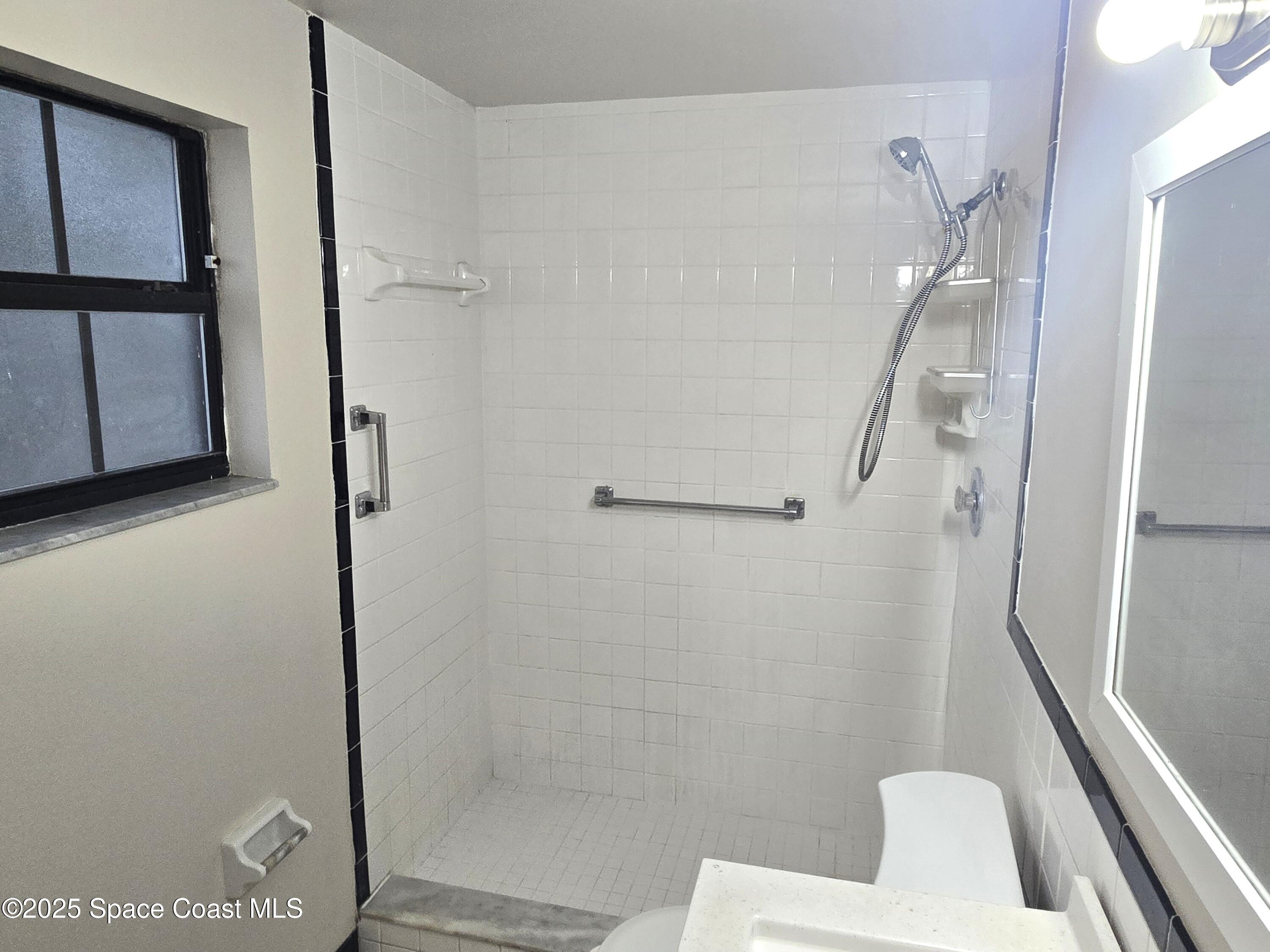 2351 Shenandoah Road Palm Bay, FL 32905 - Photo 14 of 28 a bathroom with a sink a toilet and shower