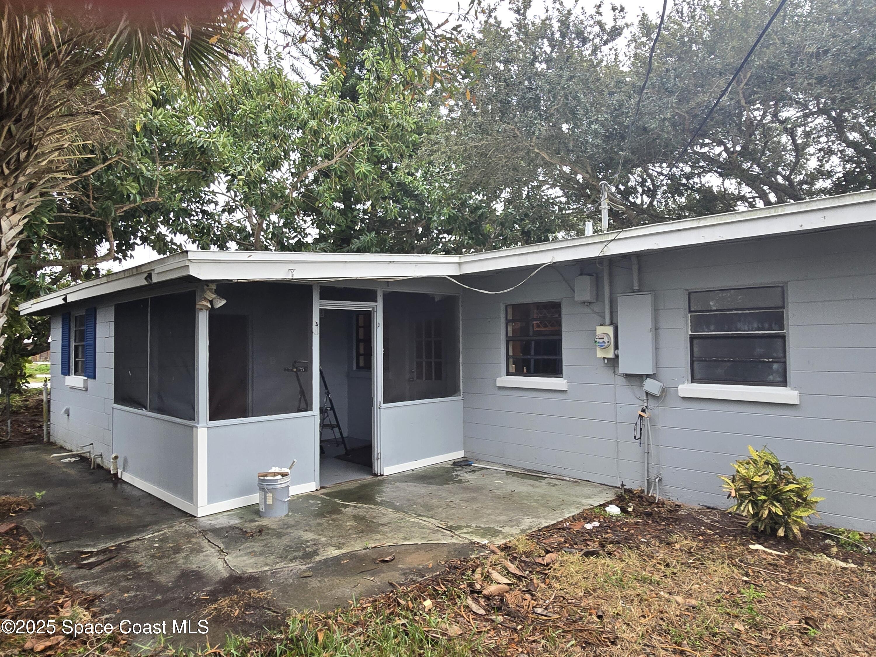 2351 Shenandoah Road Palm Bay, FL 32905 - Photo 25 of 28 a house with trees in the background