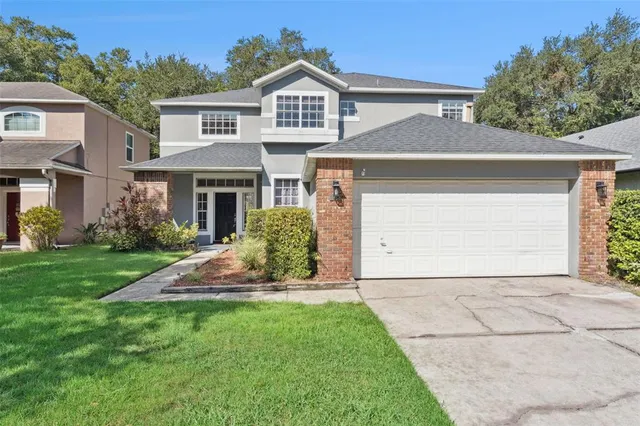 a front view of a house with a garden and plants
