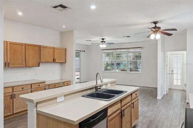 a kitchen with a sink a stove and a microwave