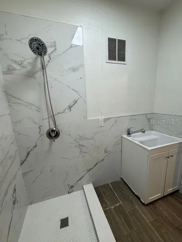 a bathroom with a sink a toilet and a shower